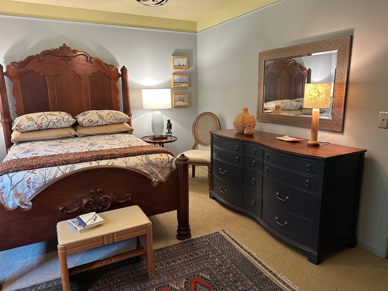 Brentwood Cove — After, antique carved bed with navy dresser and Persian rug
