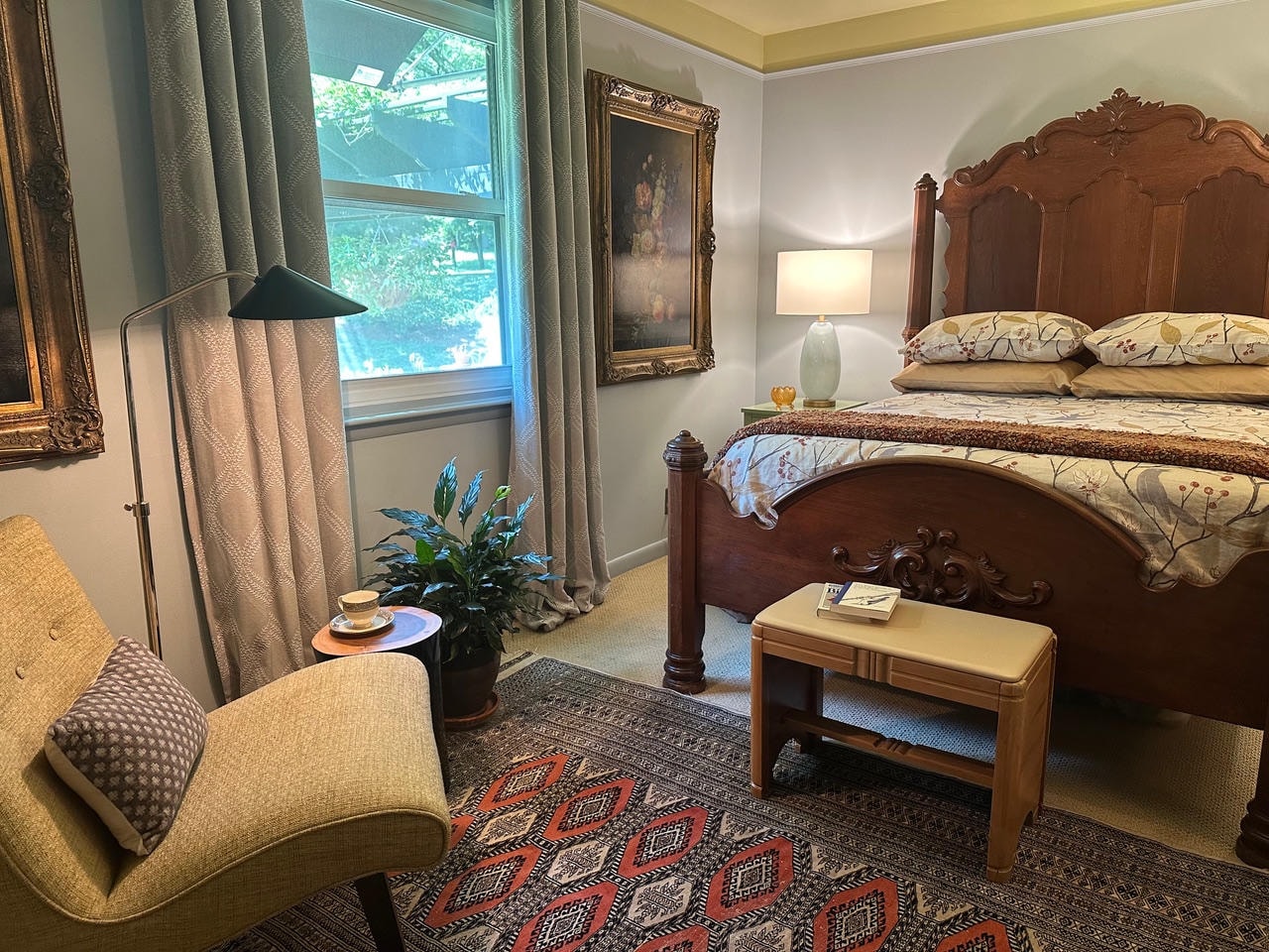 Brentwood Cove — After, bedroom sitting area with linen chair and gold-framed artwork