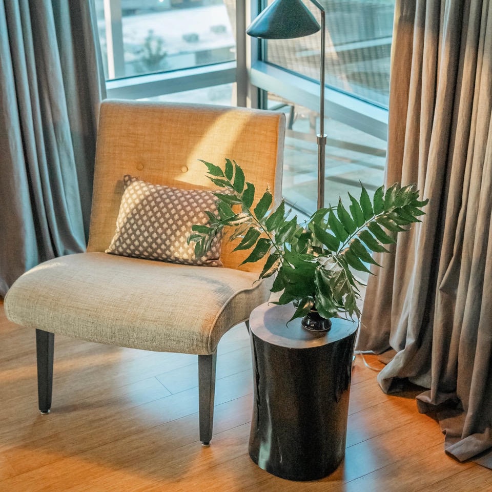 Nashville Gulch — After, reading nook with linen chair, black stump side table and floor lamp by floor-to-ceiling window