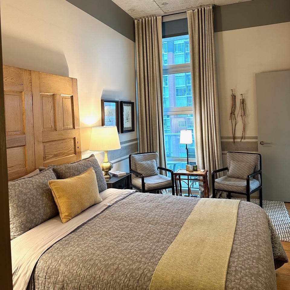 Nashville Gulch — After, guest bedroom with reclaimed wood door headboard, city view window and sitting area
