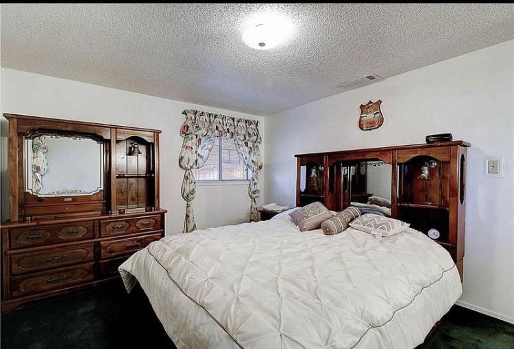 Austin Rock — Before, master bedroom with wood dresser and floral curtains