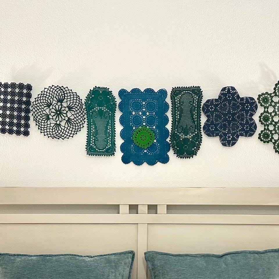 Austin Trail — After, close-up of colorful doily wall art installation above headboard