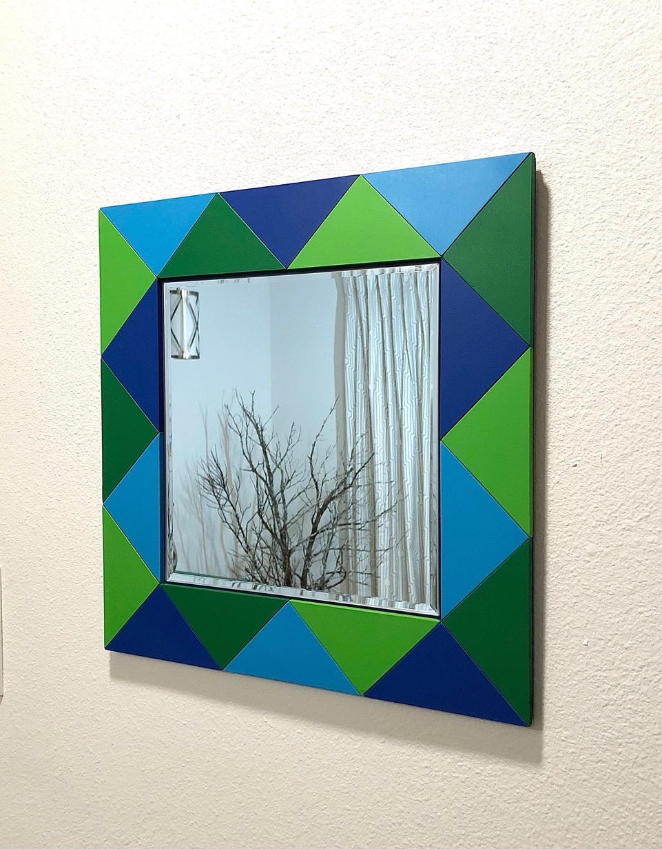 Square mirror with geometric triangular frame in green, blue and navy tones