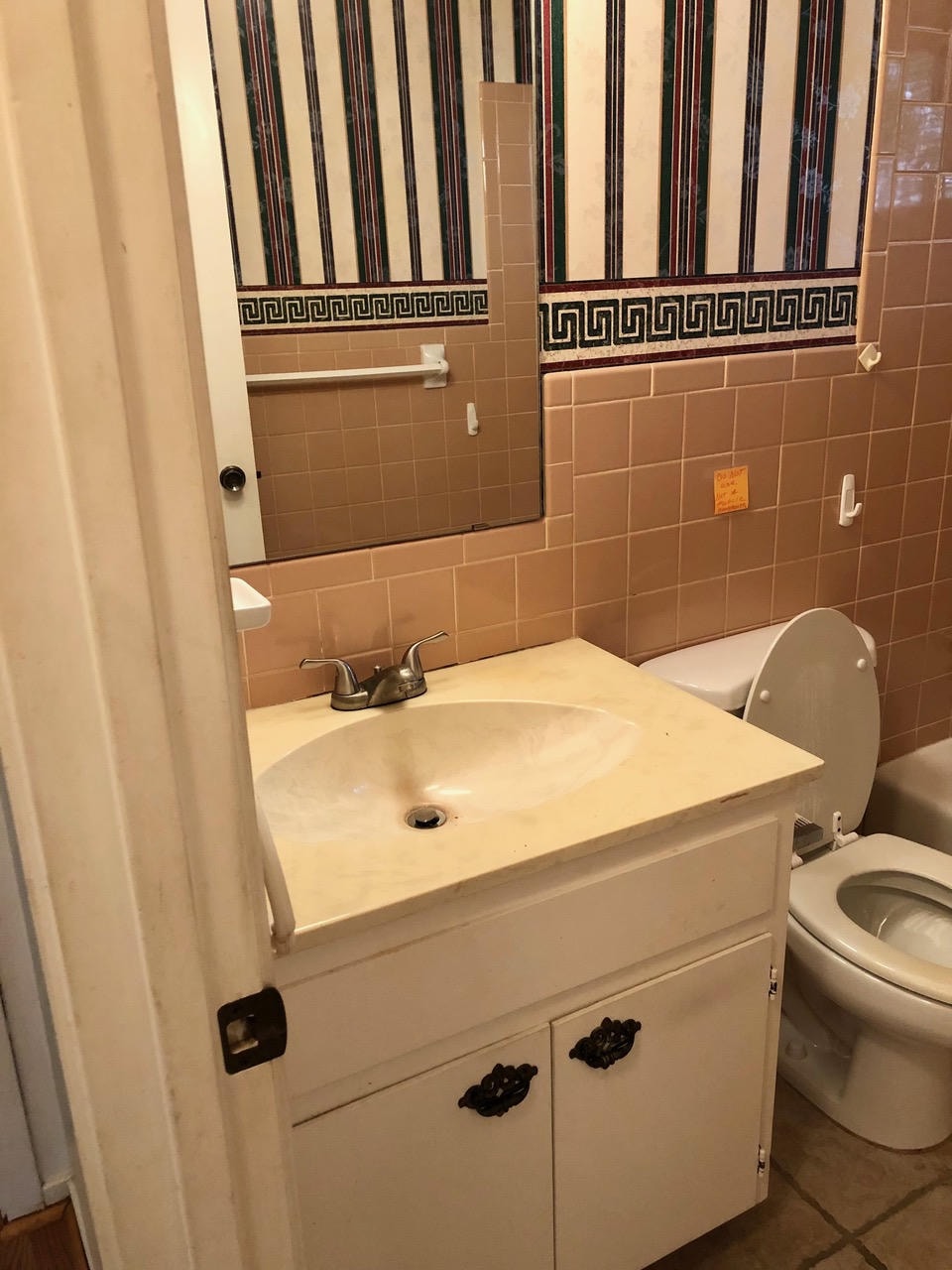 Austin Rock — Before, bathroom with tan tile and striped wallpaper