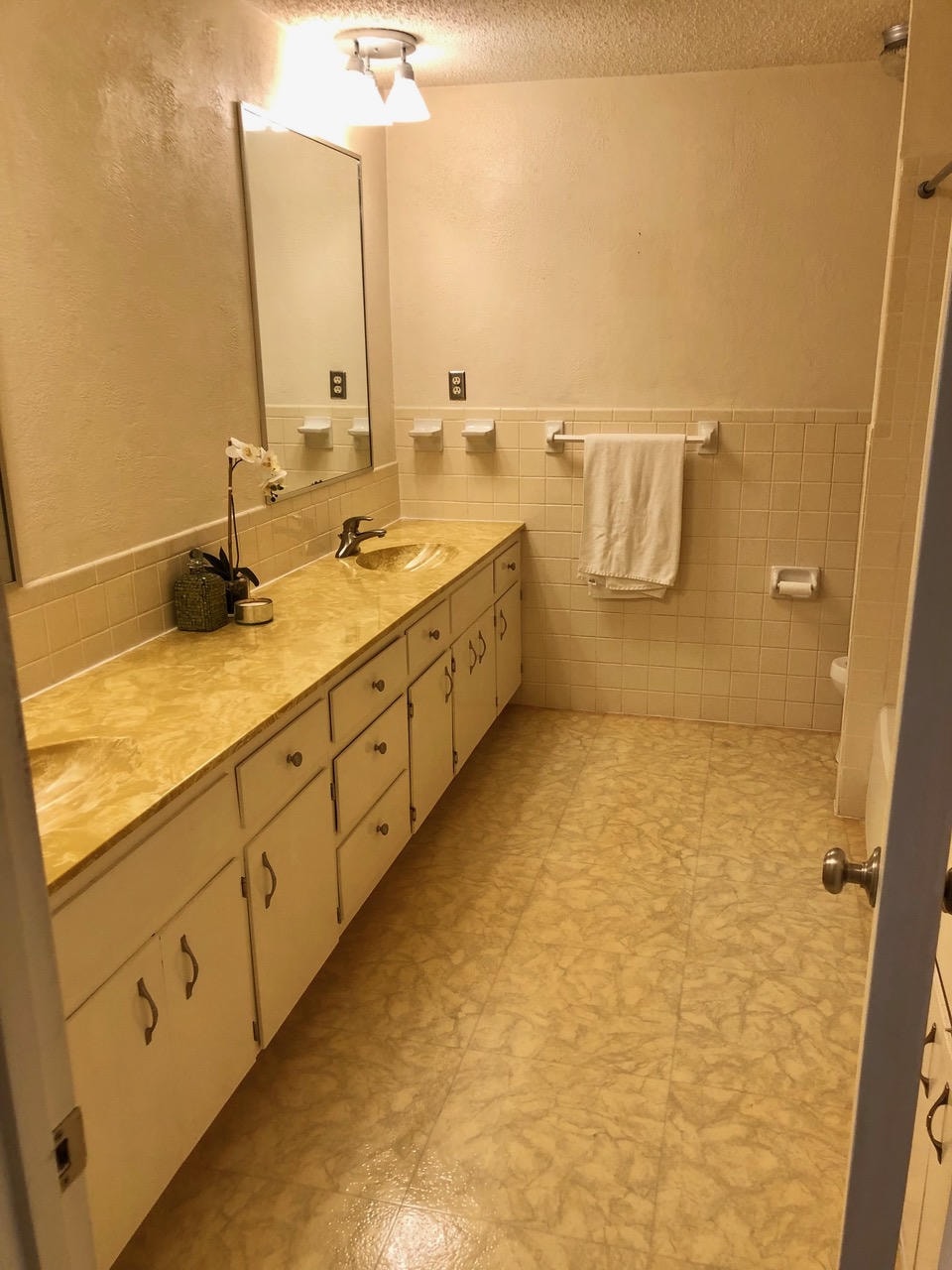 Austin Trail — Before, bathroom with single vanity, yellow tile countertop and square wall tiles
