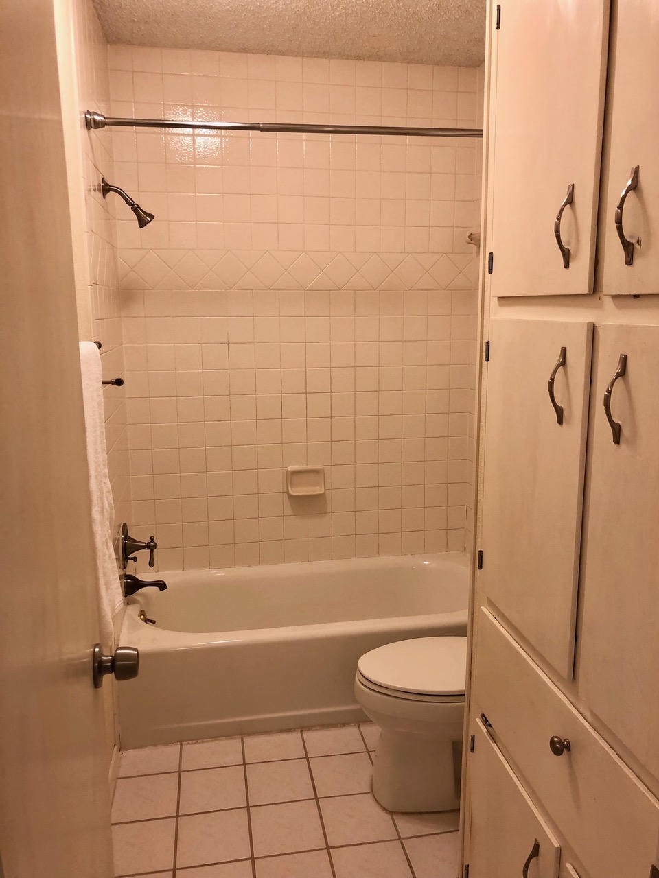 Austin Trail — Before, bathroom with tub, white tile shower and built-in cabinetry