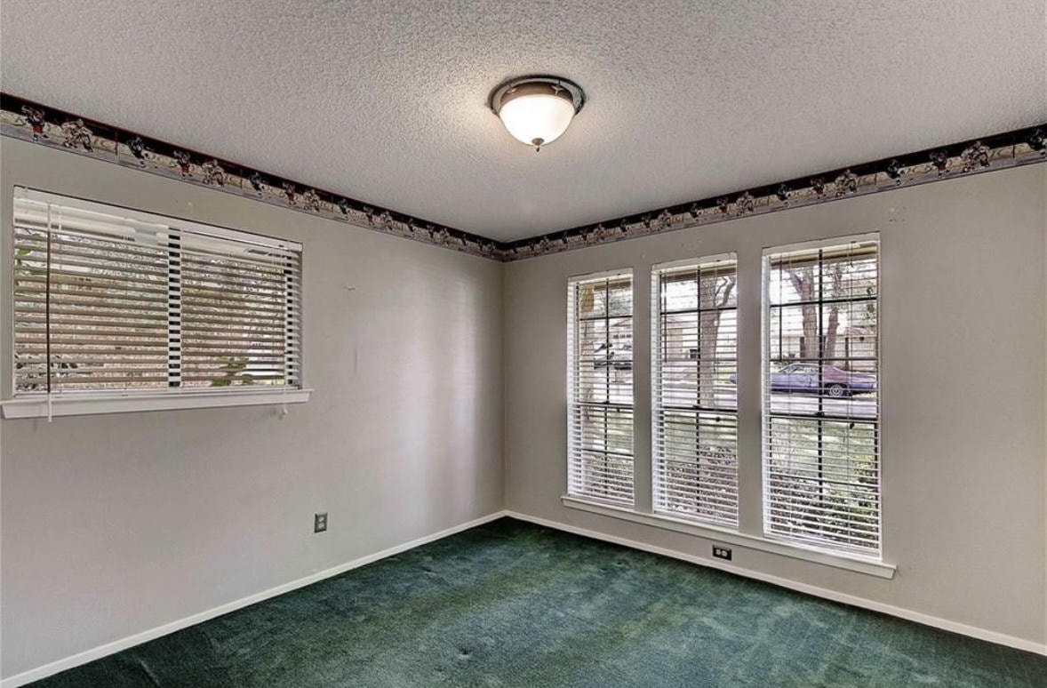 Austin Rock — Before, room with green carpet and decorative border
