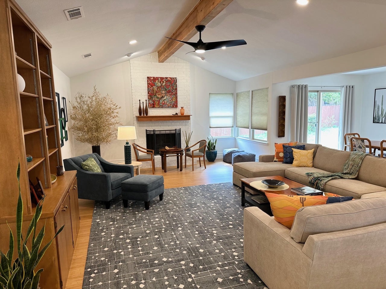 Austin Trail — After, living room with vaulted ceiling, wood beam, sectional and fireplace