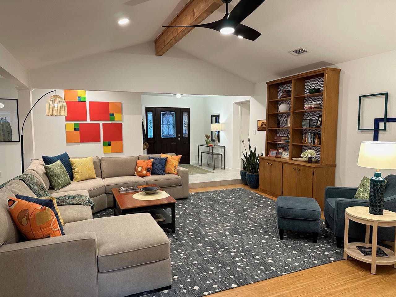 Austin Trail — After, living room with colorful wall art panels and built-in bookcase