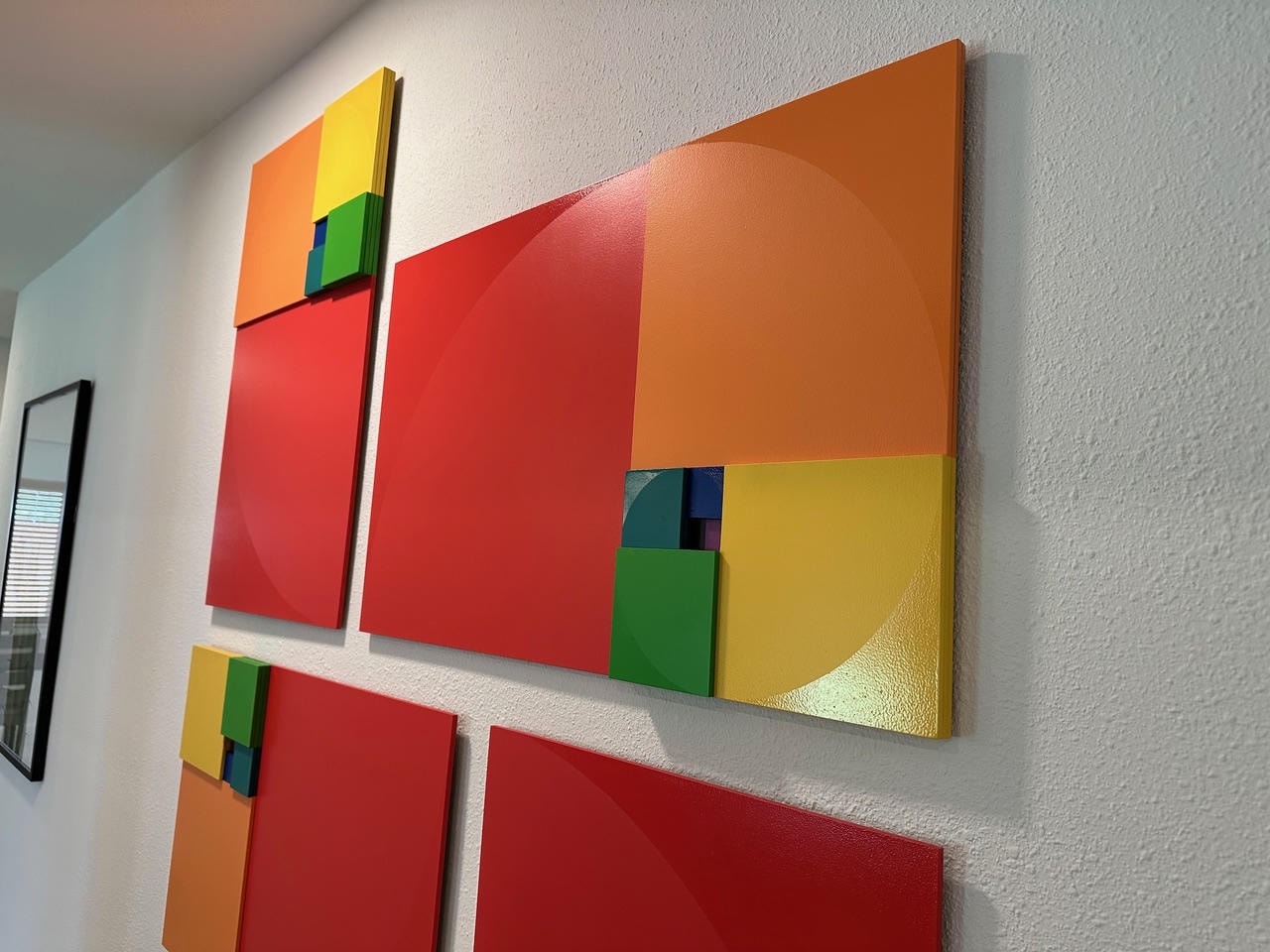 Austin Trail — After, colorful abstract geometric wall art installation with red, orange, yellow and green panels