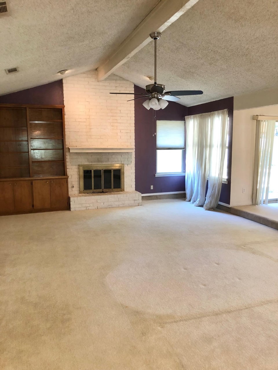 Austin Trail — Before, living room with vaulted ceiling and brick fireplace